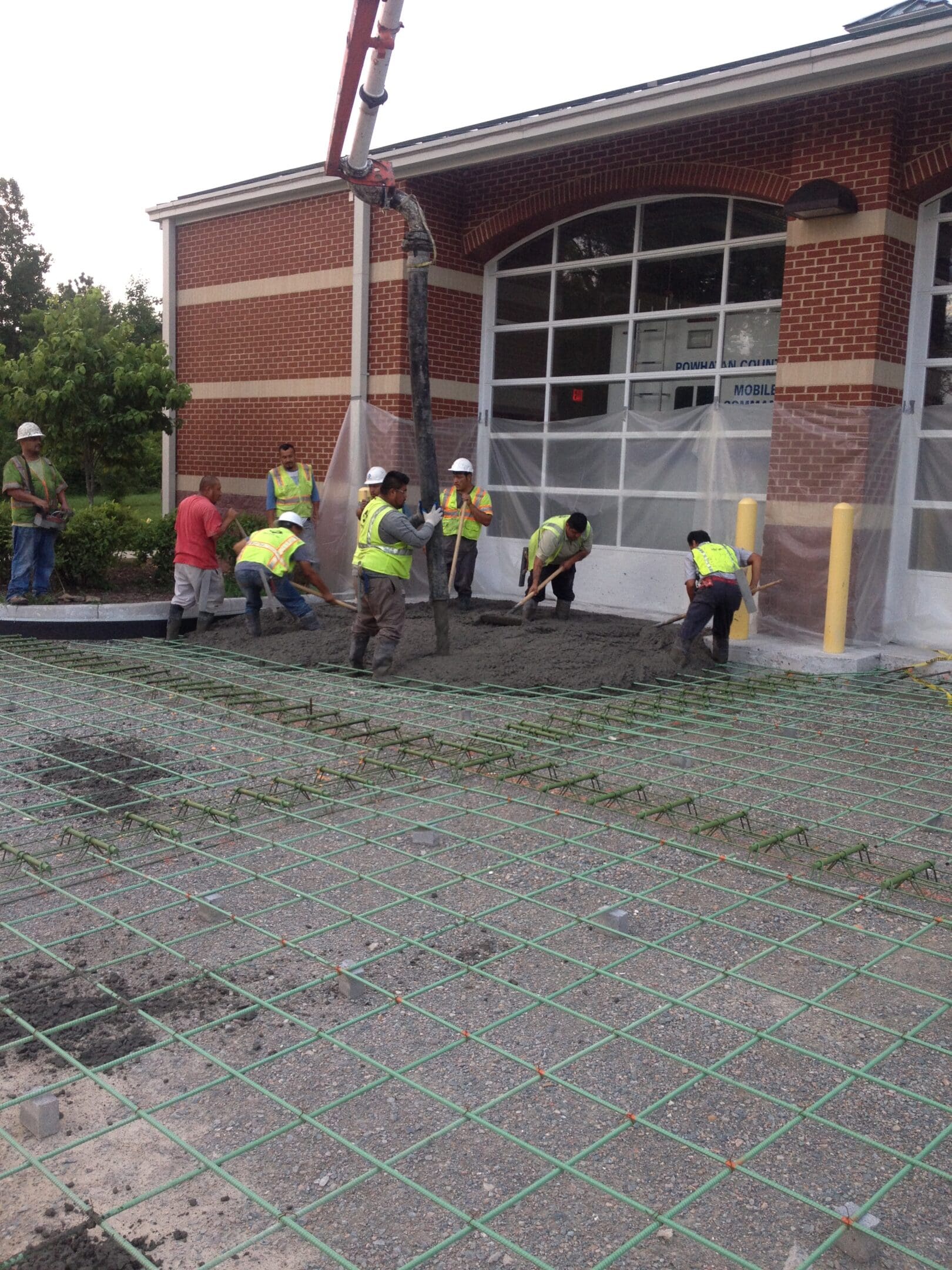 A group of people working on the sidewalk.