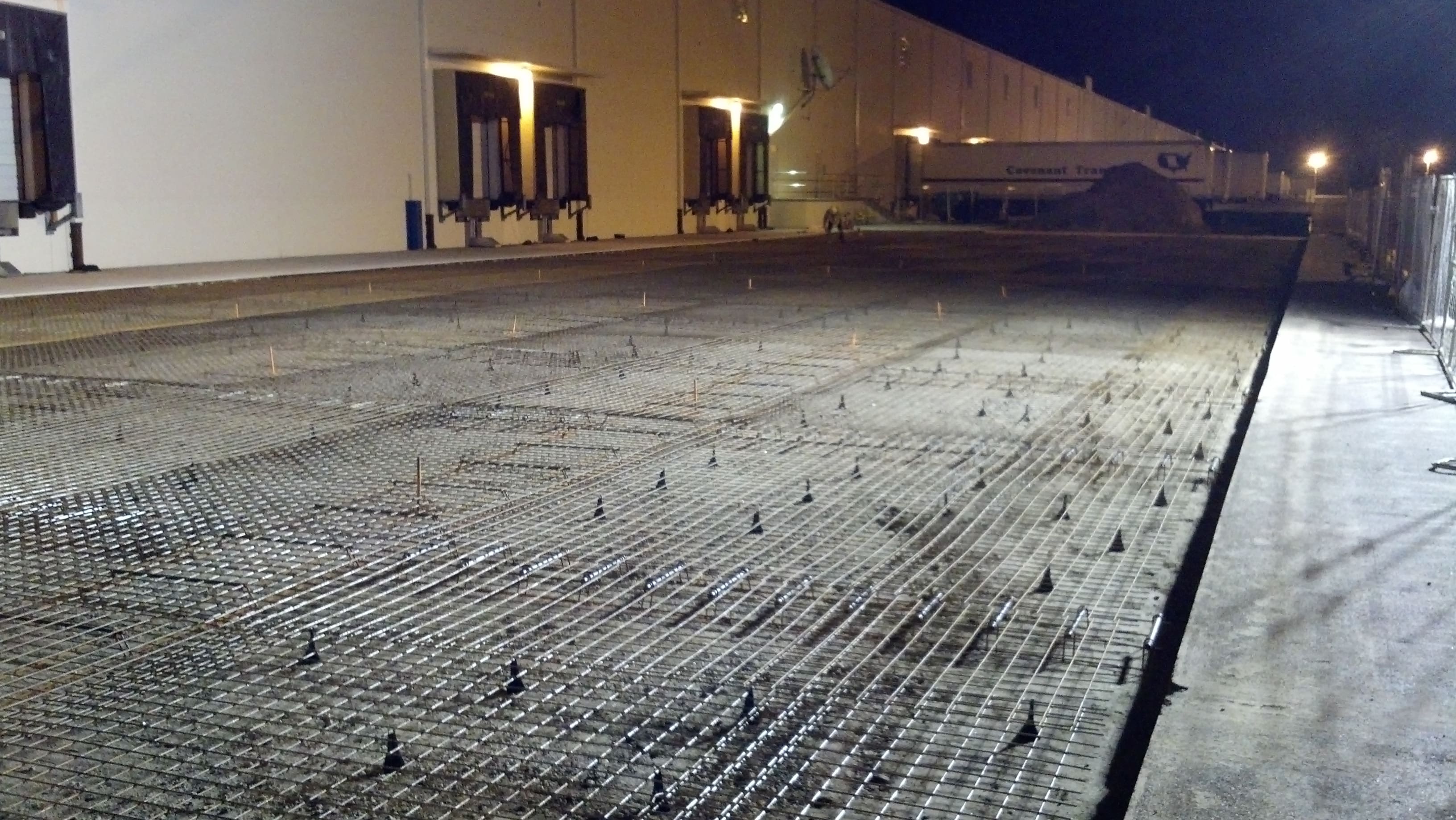 A concrete slab with many nails on it