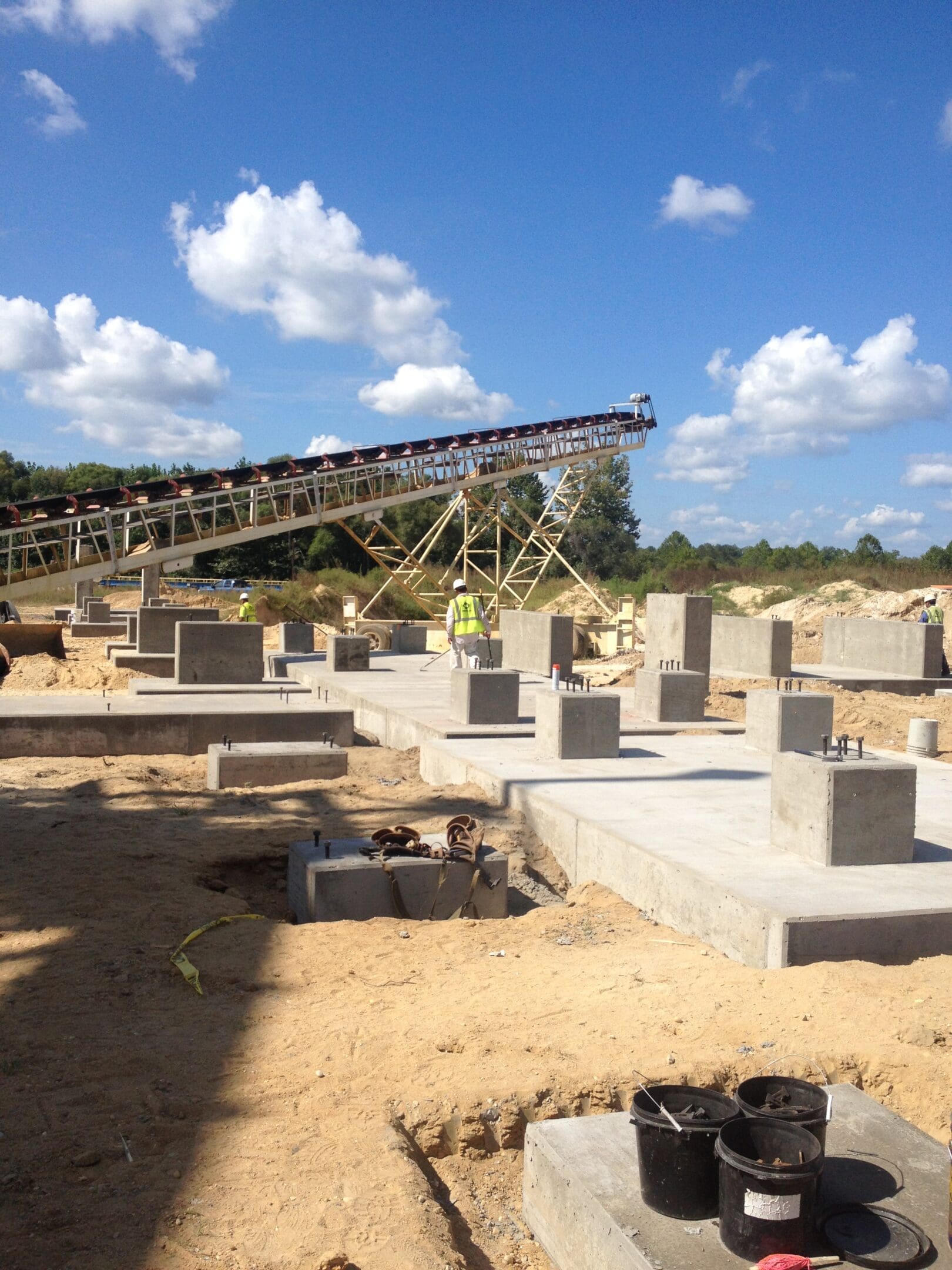 A cement pile with some steps and a conveyor belt