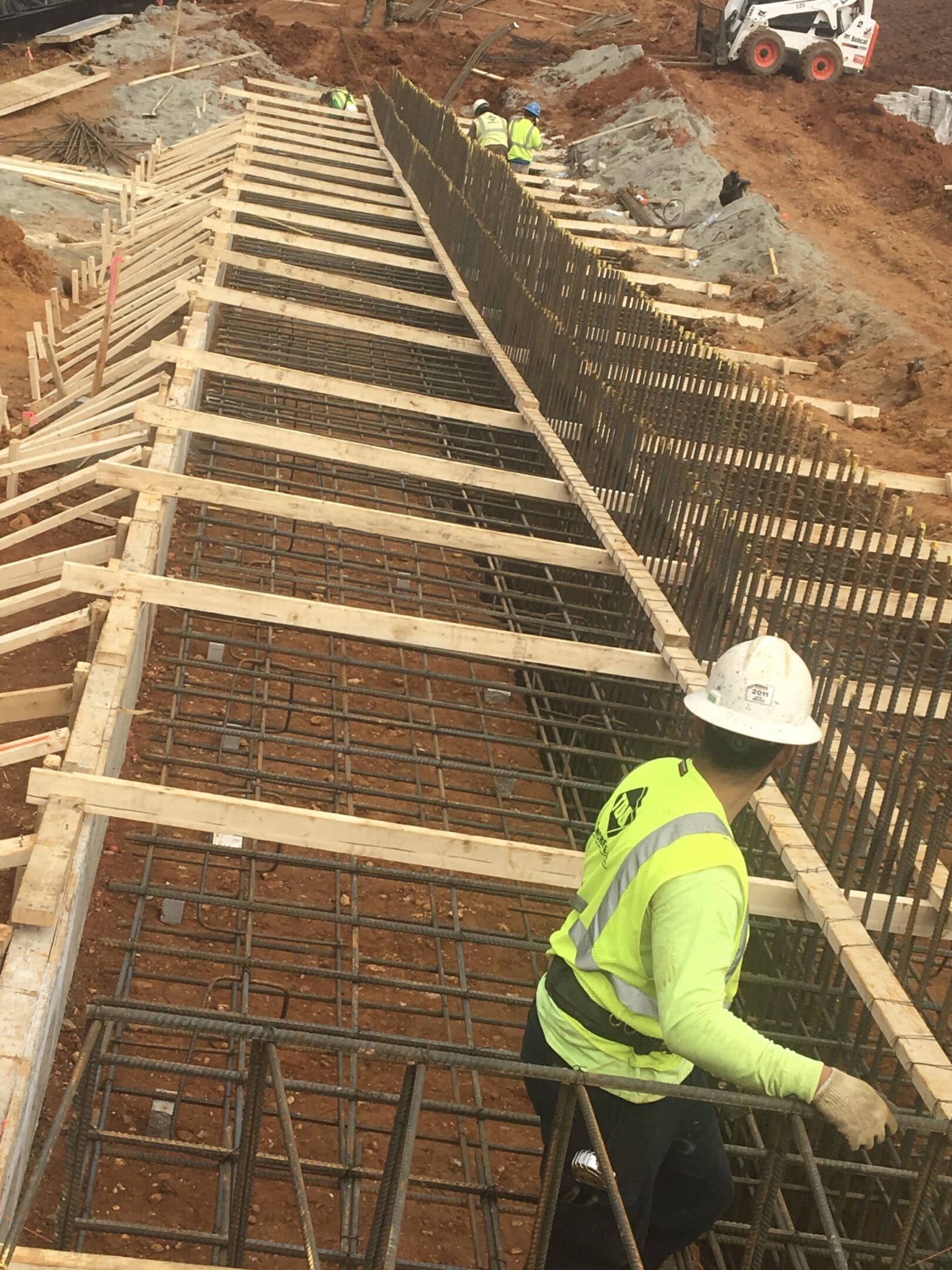 A construction worker is working on the concrete.