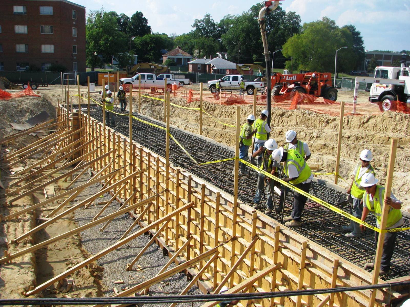 A group of construction workers working on the side of a road.