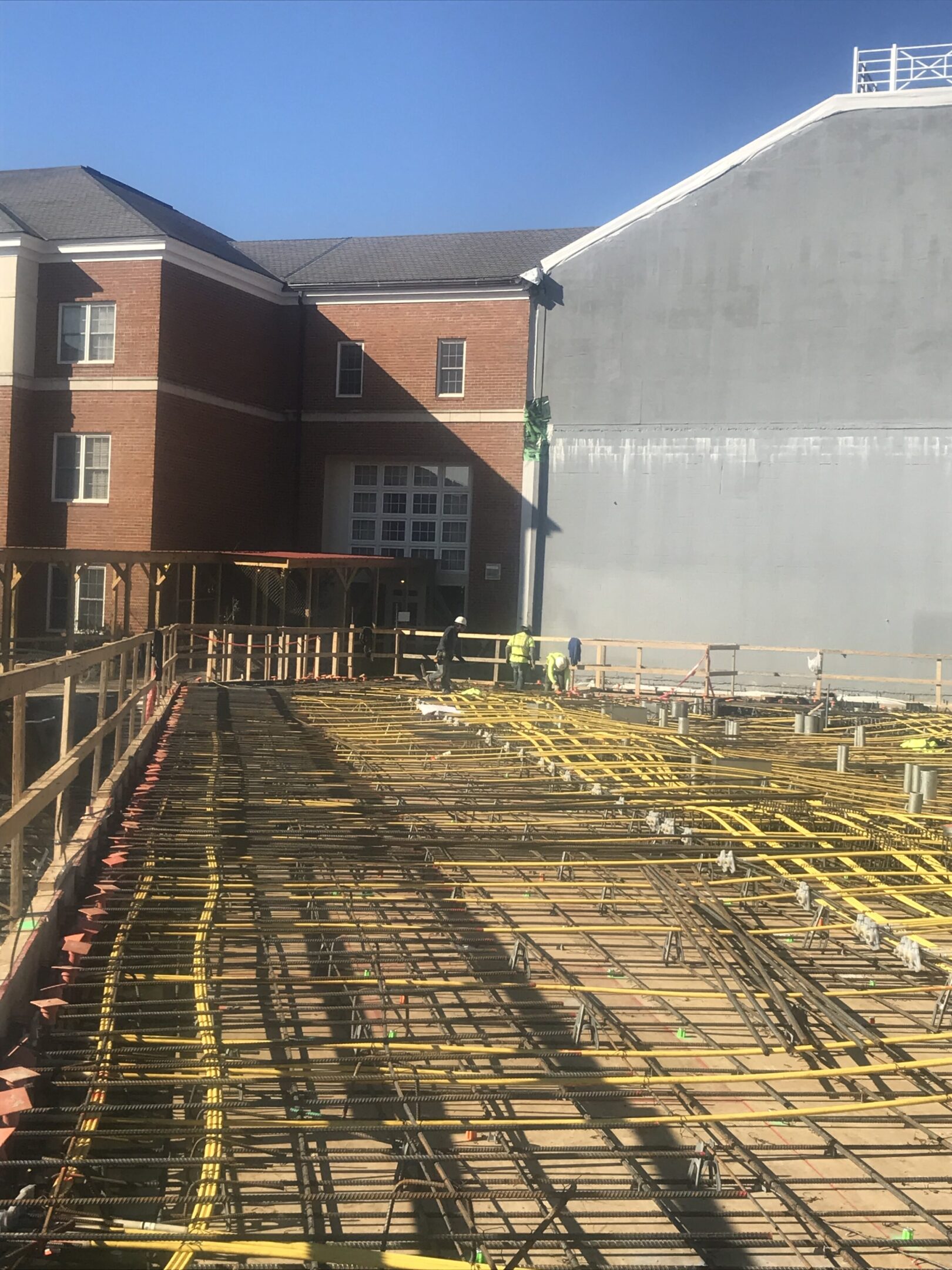 A building with many yellow pipes on the ground.