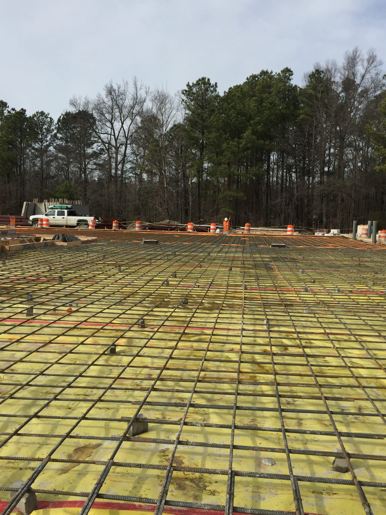 A large concrete slab being poured for a building.