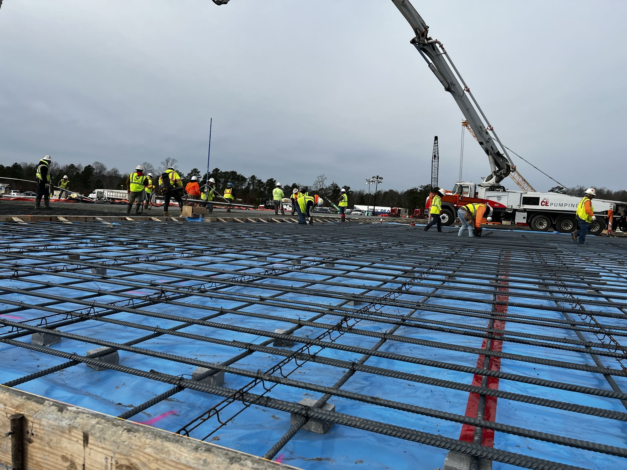 A group of people standing around on top of a concrete slab.