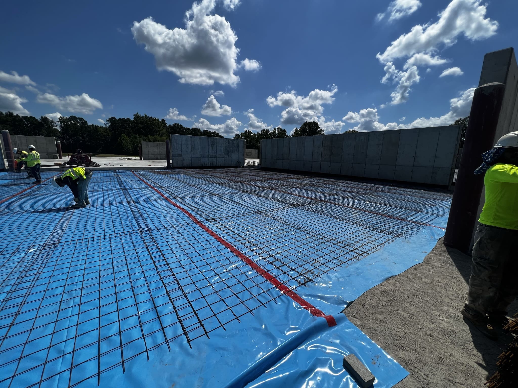 A man working on the ground in front of a building.