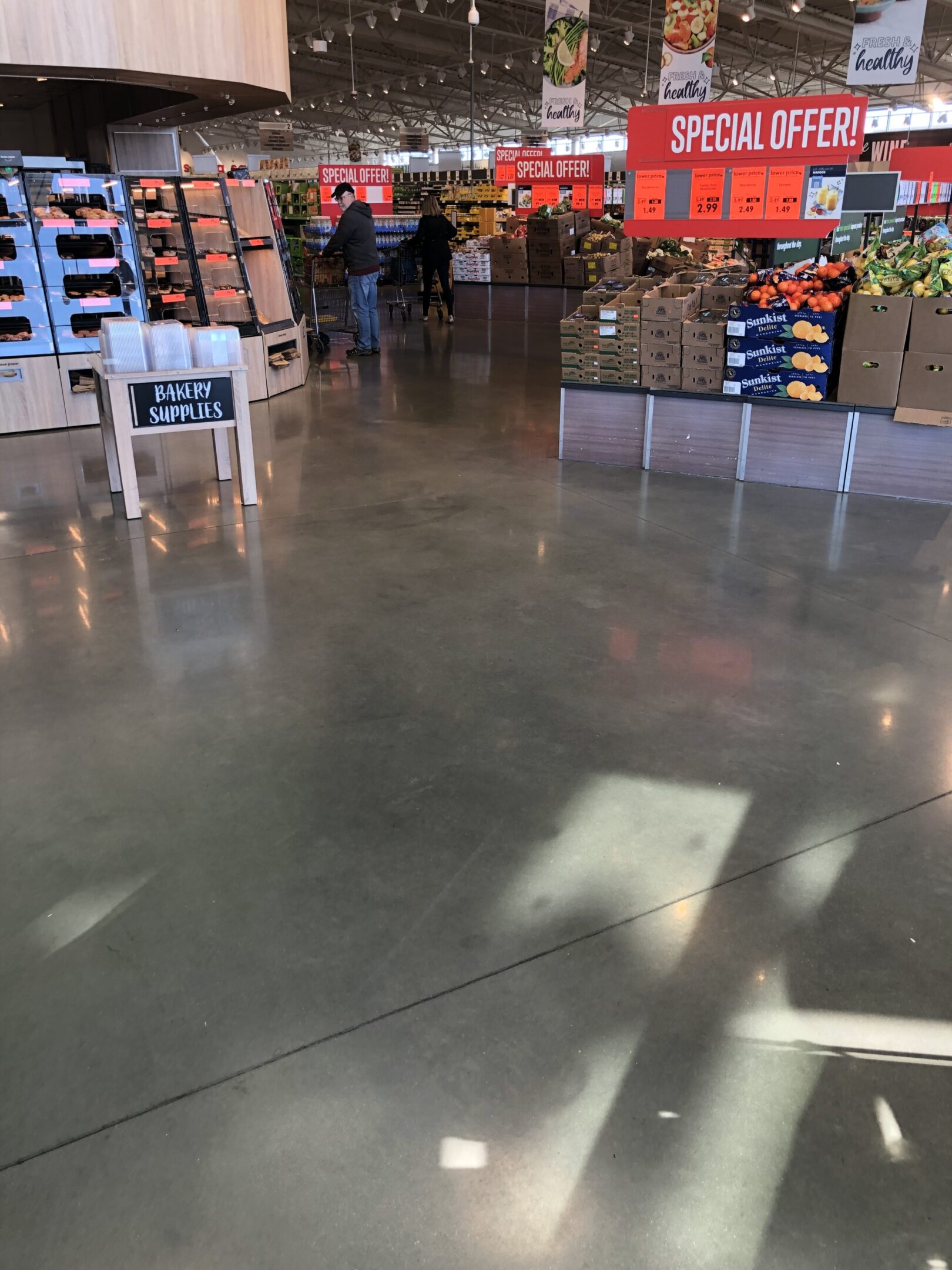 A store floor with lots of boxes and people.