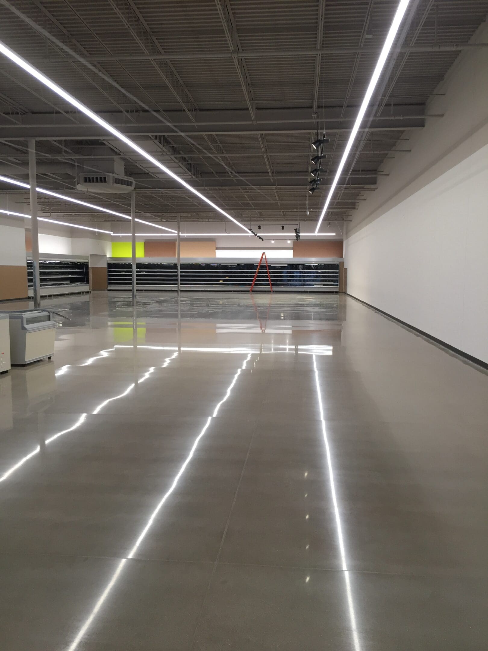 A large empty room with lights on the ceiling.