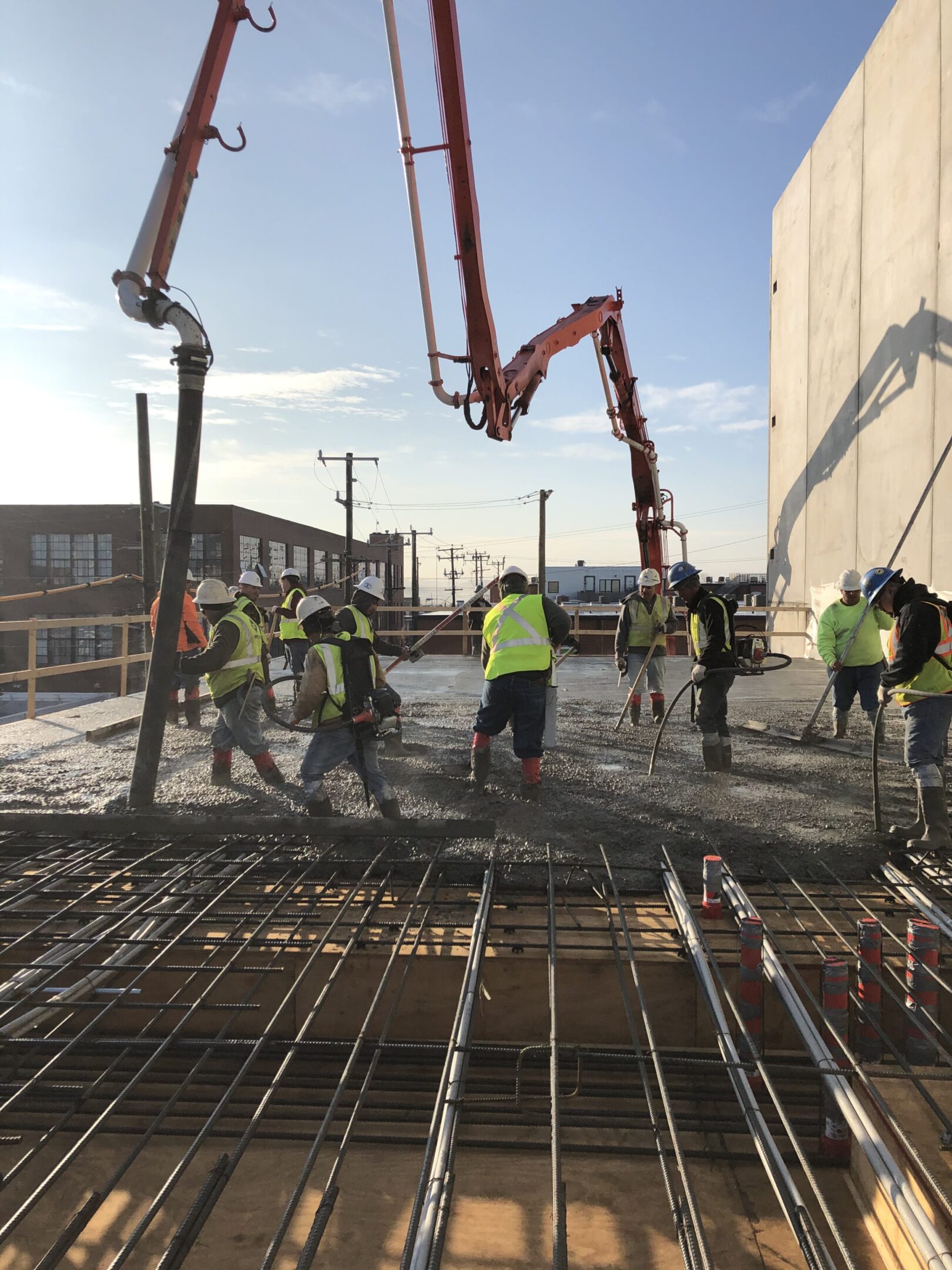 A group of people standing around on concrete.