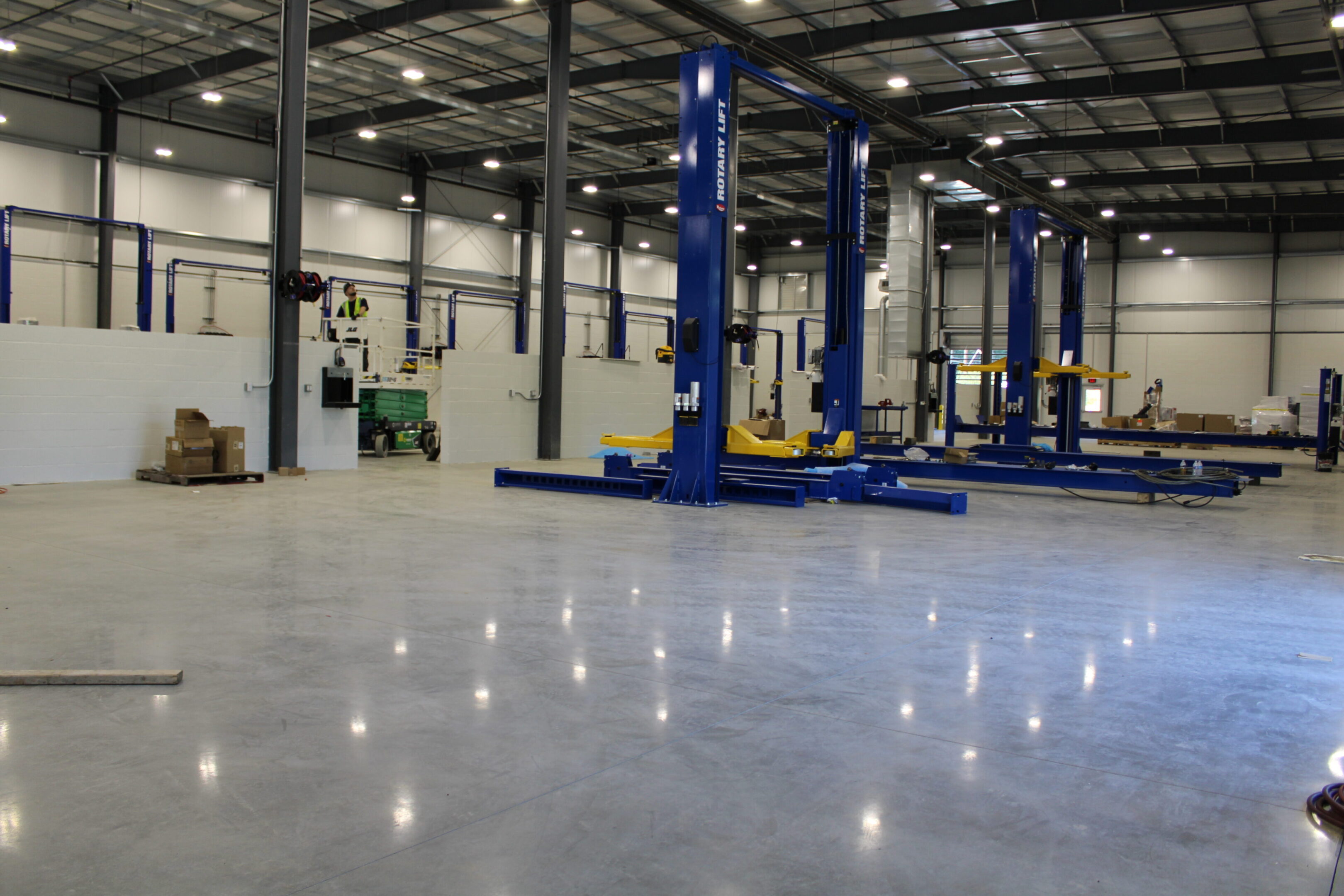 A large warehouse with two lifts and a lot of lights