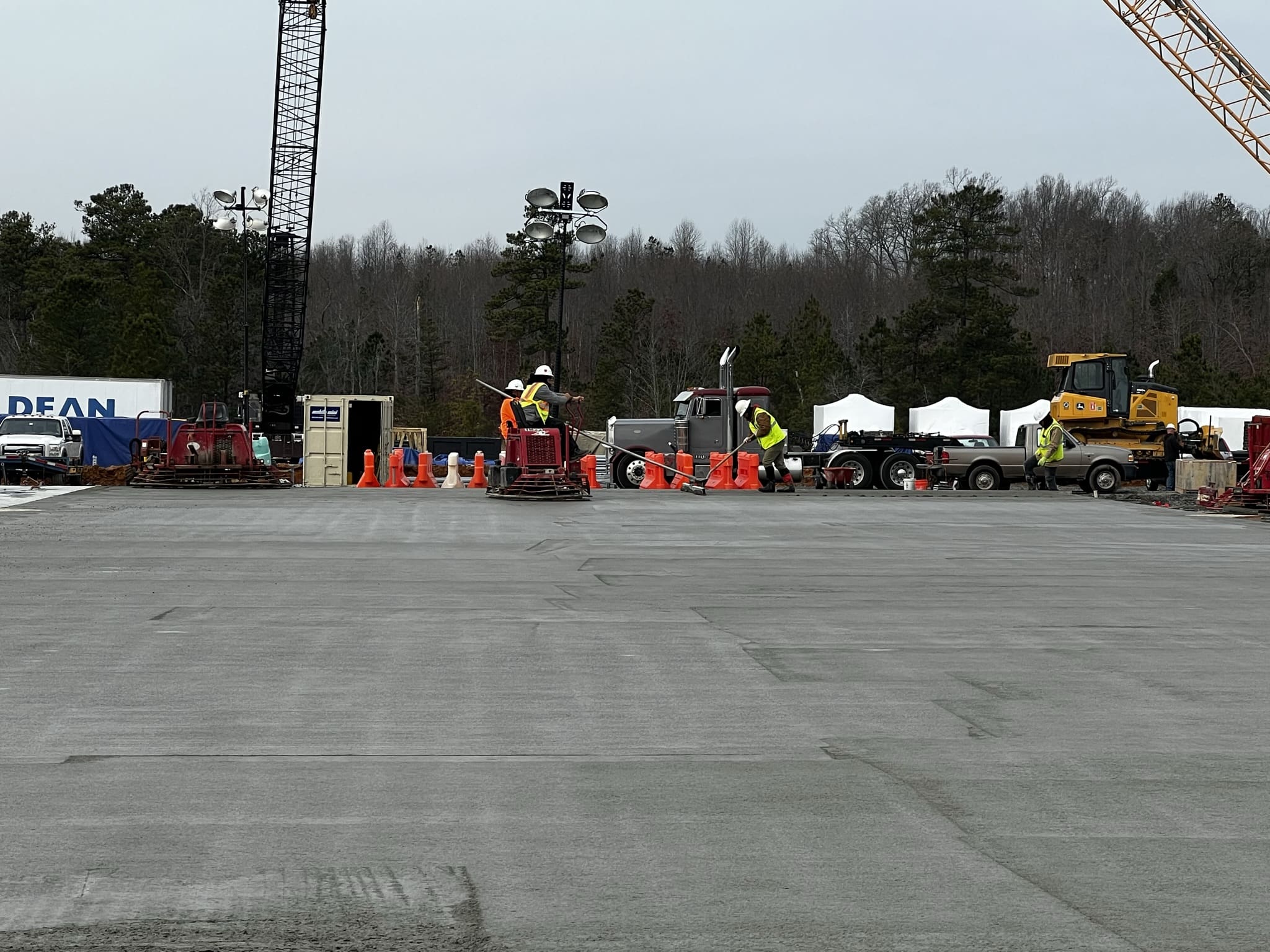 A construction site with workers and equipment on the ground.