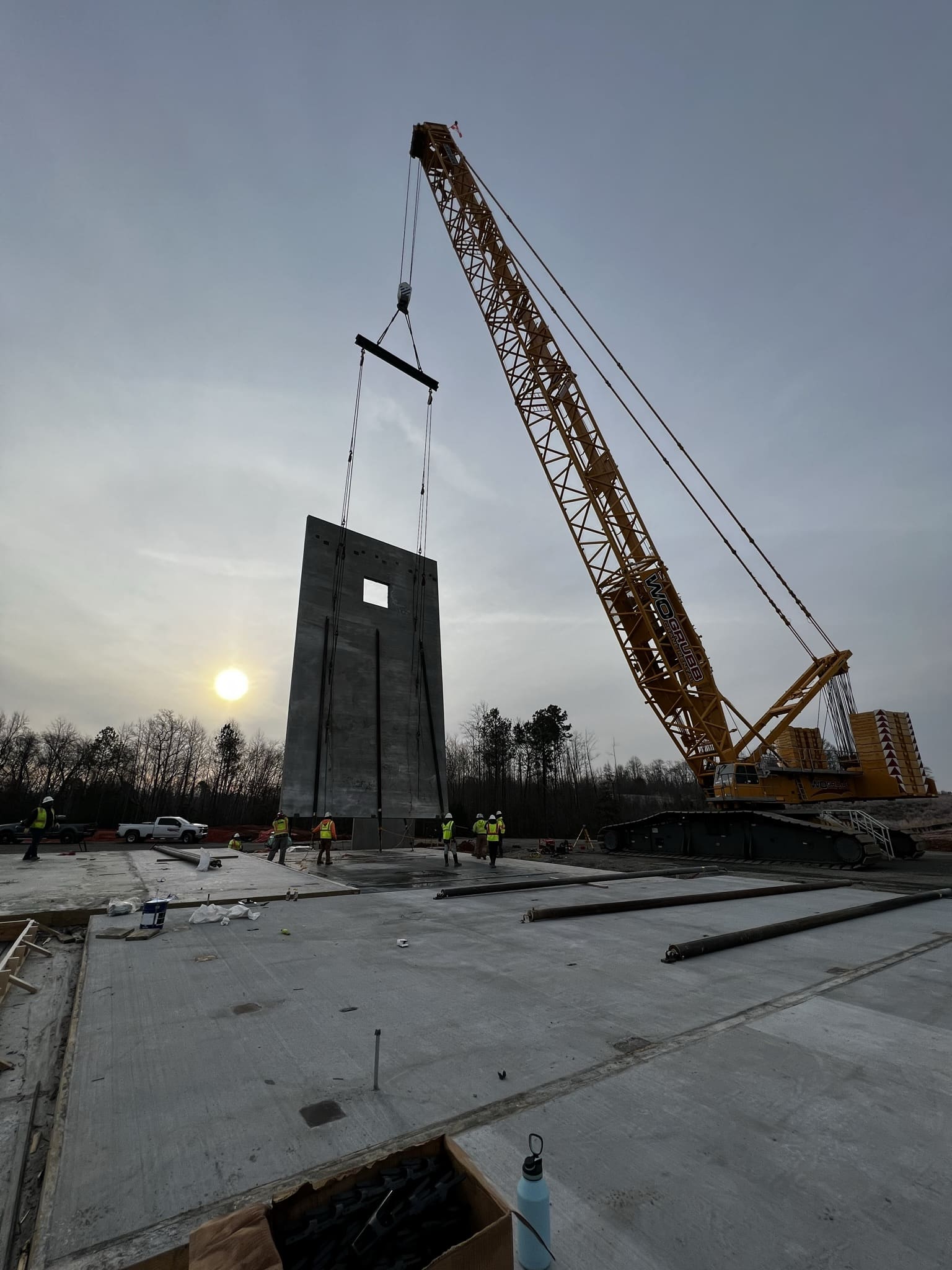 A crane is lifting a large piece of metal.