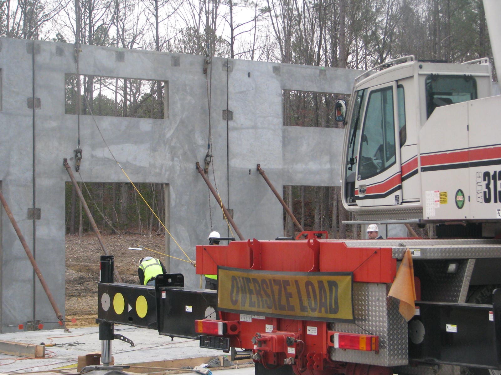 A construction truck parked next to a building.