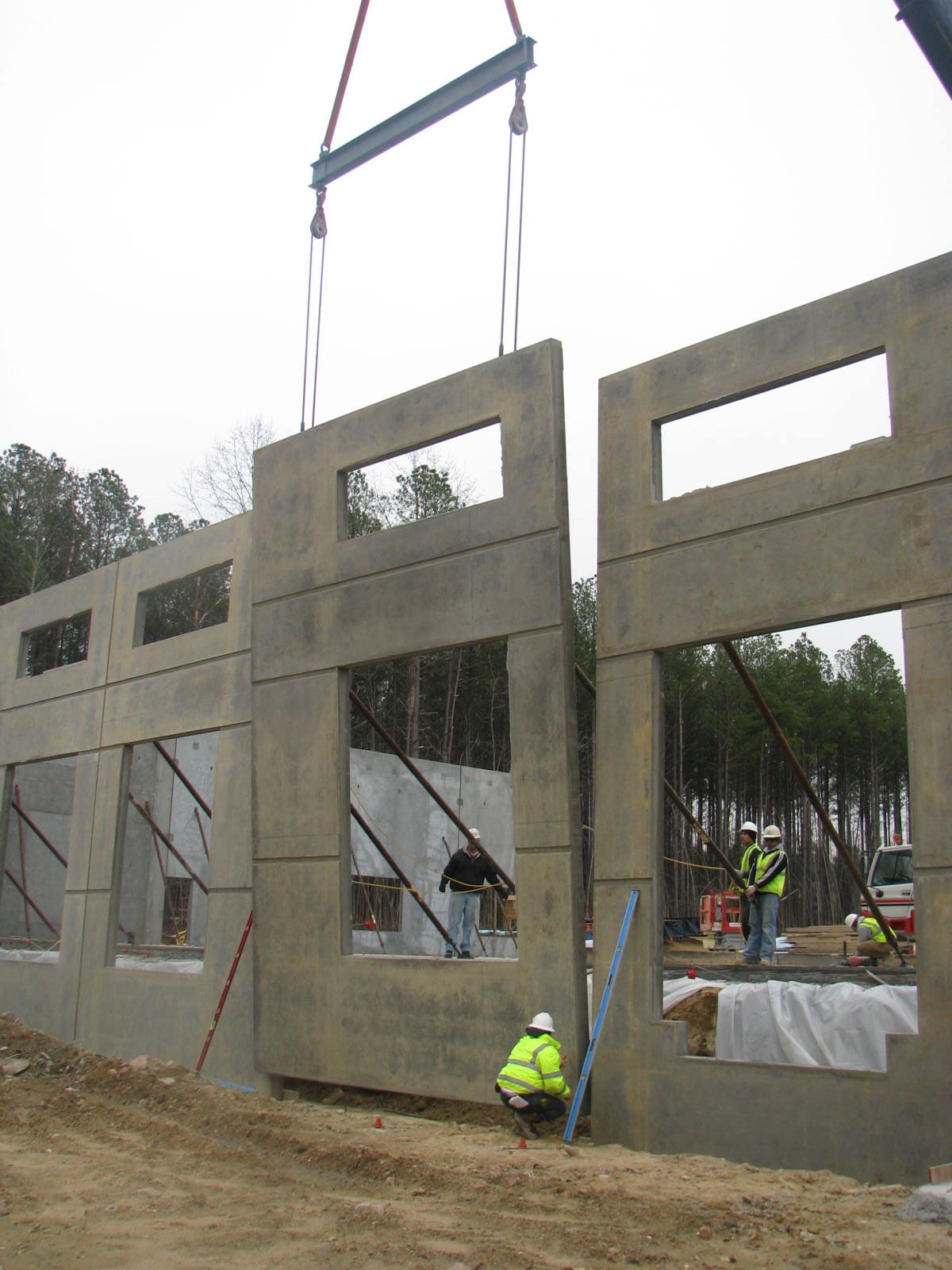 A building being built with concrete blocks and windows.