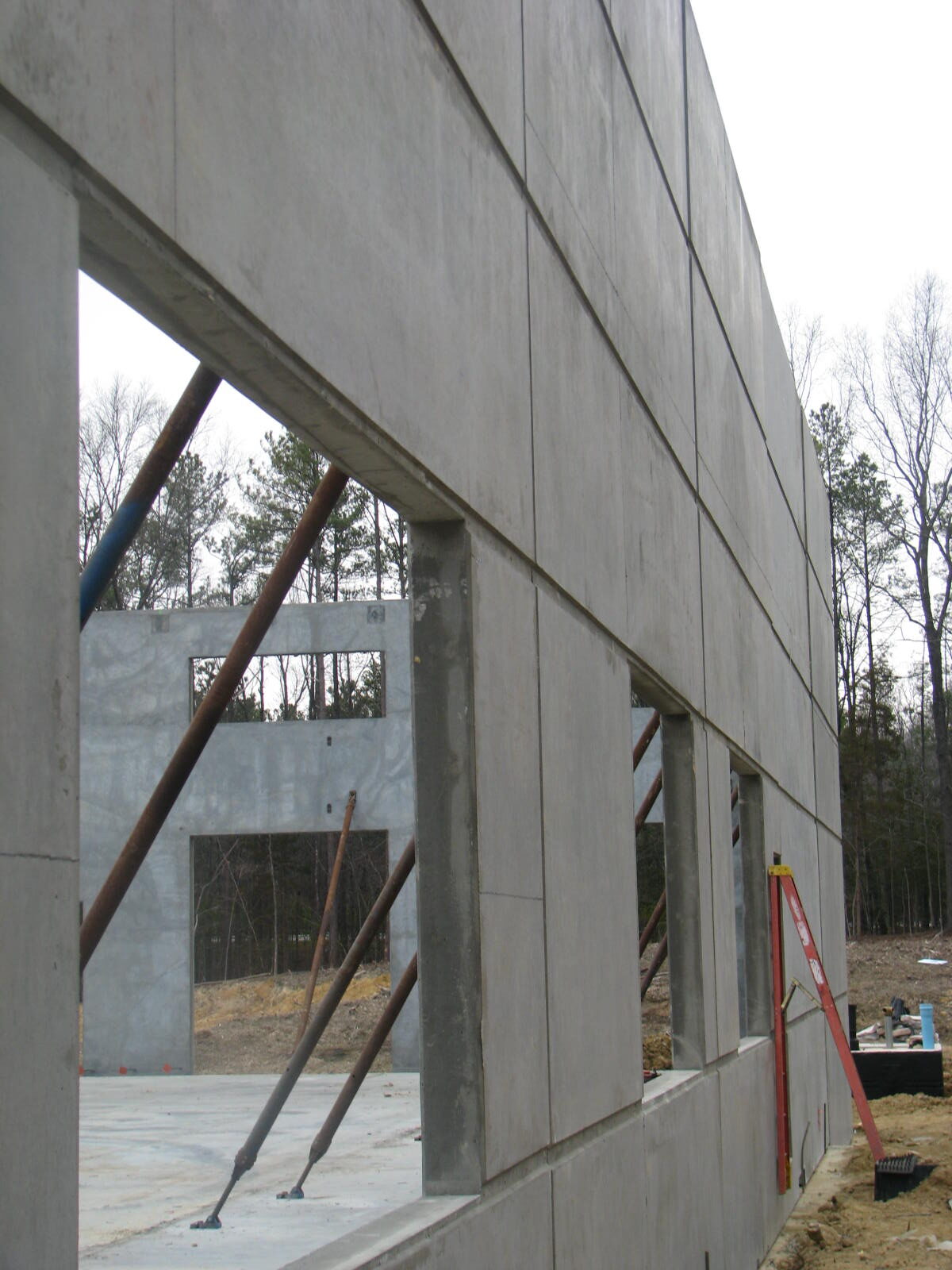 A building under construction with windows being opened.