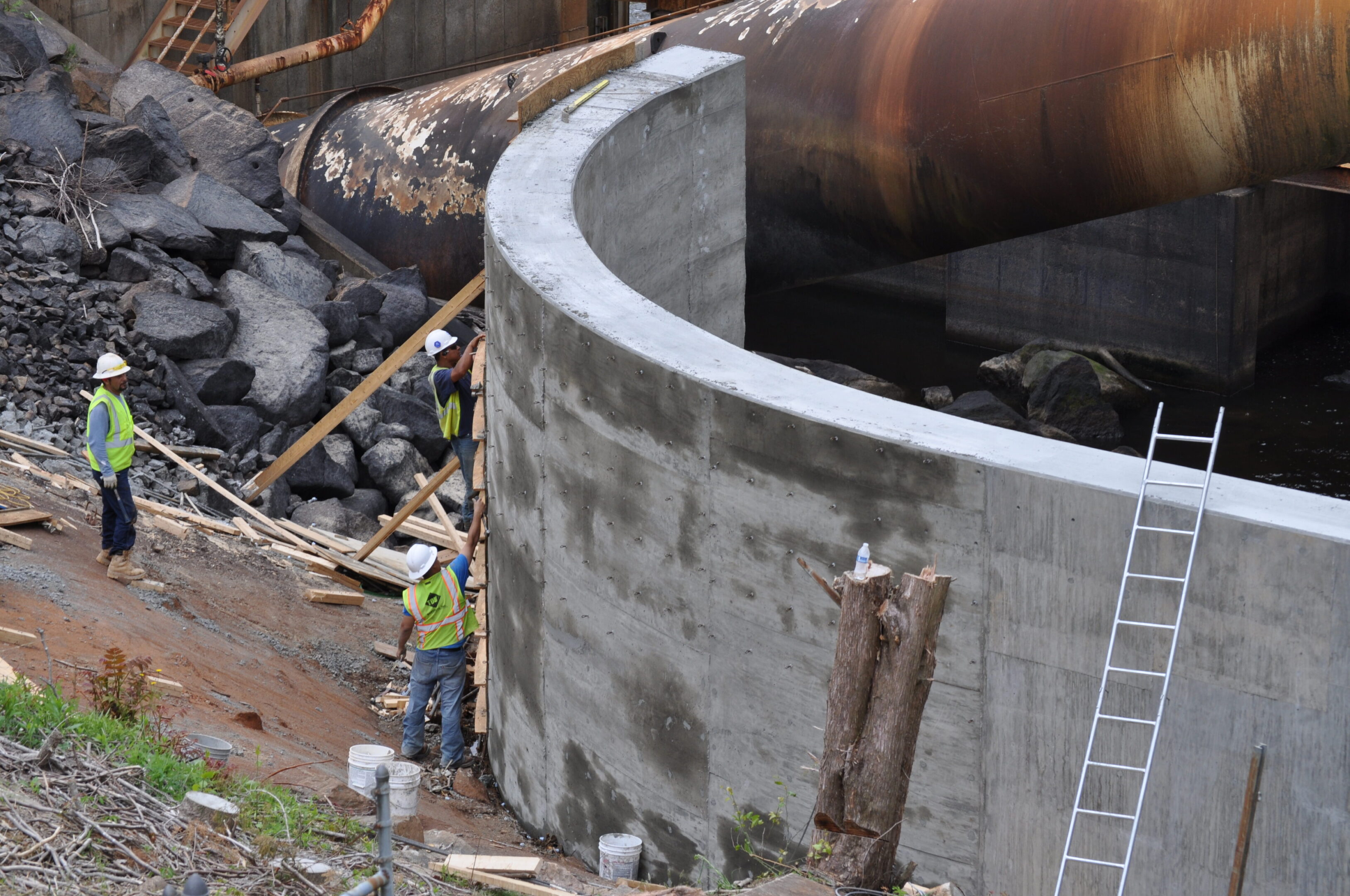 A man standing next to a large concrete structure.