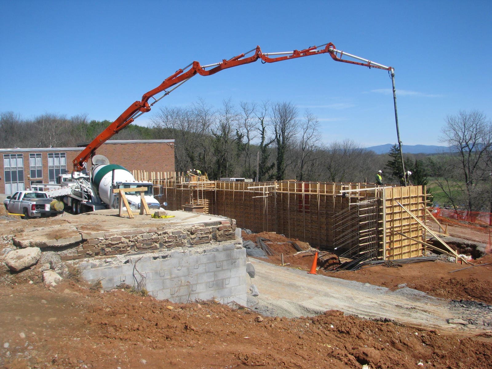 A crane is in the air over a construction site.