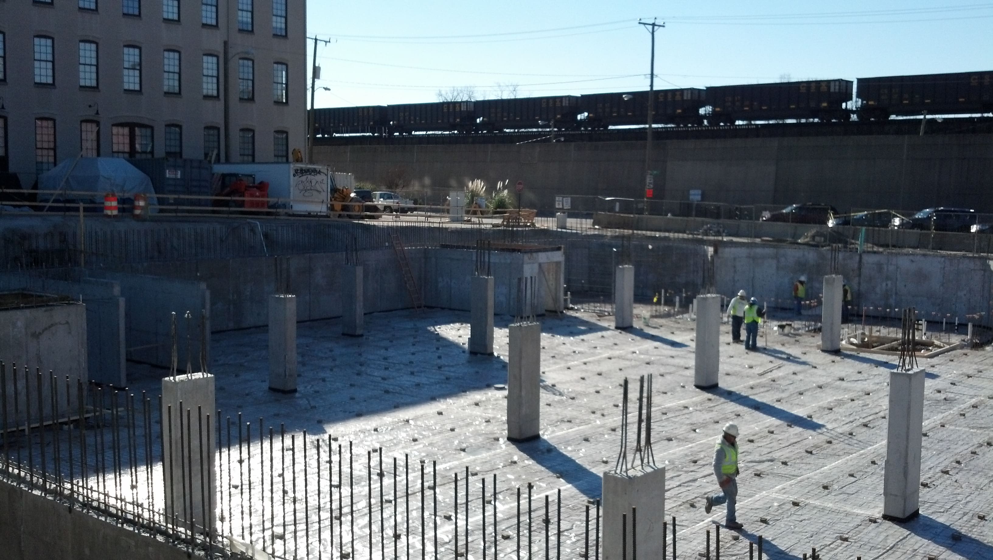 A construction site with workers standing around.