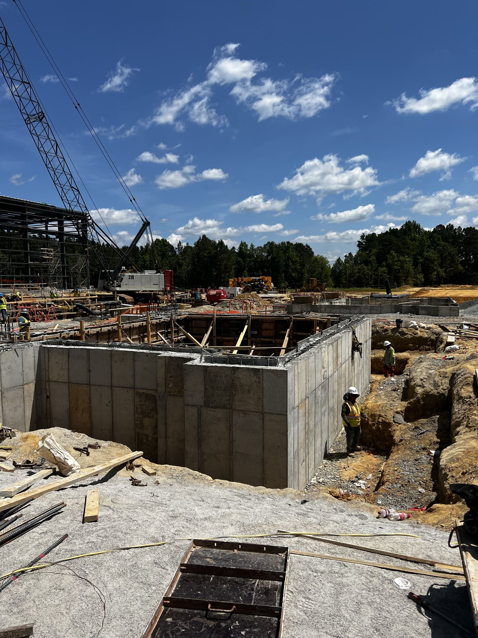 A building under construction with trees in the background.